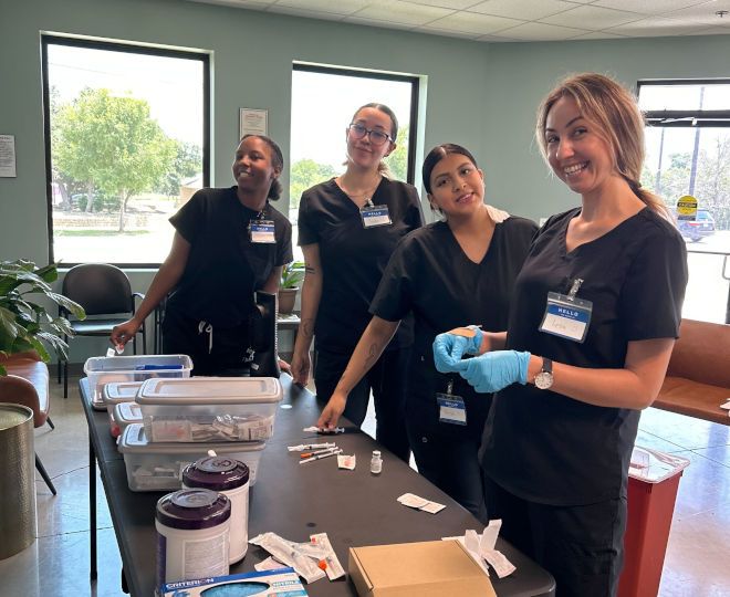 Medical students in lab working with syringes